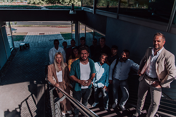 Image showing A diverse group of businessmen and colleagues walking together by their workplace, showcasing collaboration and teamwork in the company.