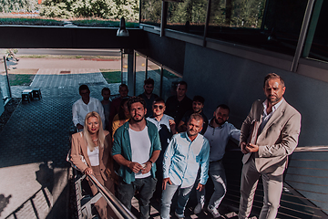 Image showing A diverse group of businessmen and colleagues walking together by their workplace, showcasing collaboration and teamwork in the company.