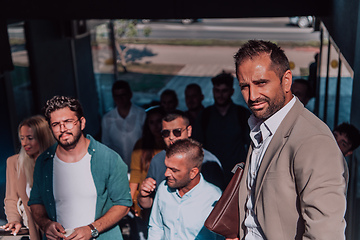 Image showing A diverse group of businessmen and colleagues walking together by their workplace, showcasing collaboration and teamwork in the company.