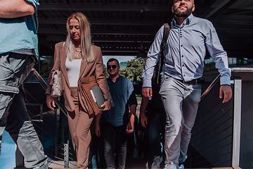 Image showing A diverse group of businessmen and colleagues walking together by their workplace, showcasing collaboration and teamwork in the company.