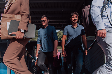 Image showing A diverse group of businessmen and colleagues walking together by their workplace, showcasing collaboration and teamwork in the company.