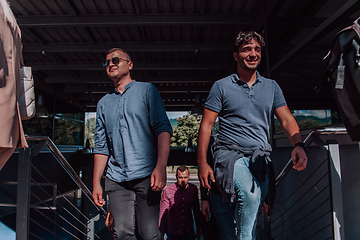 Image showing A diverse group of businessmen and colleagues walking together by their workplace, showcasing collaboration and teamwork in the company.