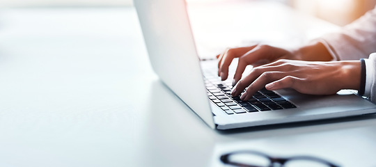 Image showing Hands, laptop and a business woman typing on space in the office while working on a report or research. Computer, mockup and flare with a professional employee closeup at a desk in the workplace