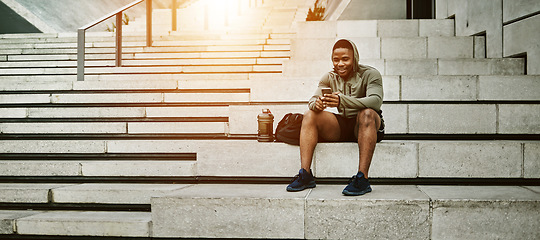 Image showing Outdoor, fitness and black man with smartphone, stairs and online reading with social media, connection and relax. African person, healthy runner and athlete with cellphone, digital app and network