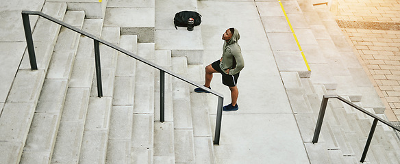 Image showing Tired black man, stairs and fitness on break from running, exercise or outdoor workout in city. Banner of African male person, athlete or runner in rest, recovery or training on steps in urban town