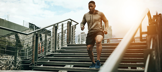 Image showing Fitness, city and black man running on steps outdoor, exercise and training healthy body in the morning. Sports, cardio and African athlete on stairs for endurance workout, energy or jog for wellness