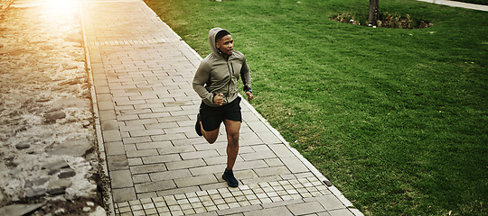 Image showing Fitness, park and black man running outdoor, exercise and training healthy body in the morning. Sports, cardio and African athlete at garden for workout, energy and jog for wellness, marathon or race