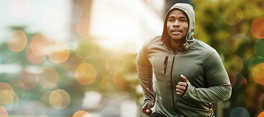 Image showing Fitness, bokeh and black man running outdoor, exercise or training healthy body in the morning in winter. Sport, cardio and African athlete workout, jog for wellness or energy for endurance in nature