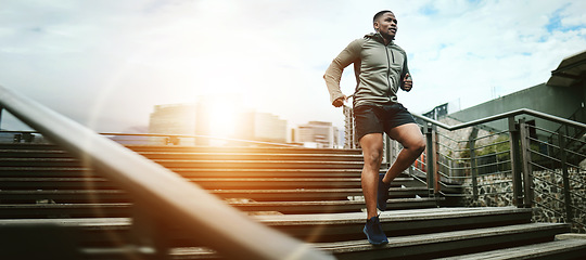 Image showing Fitness, city and black man running on steps outdoor, exercise and training healthy body in the morning at sunrise. Sports, cardio and African athlete on stairs for workout, wellness and lens flare