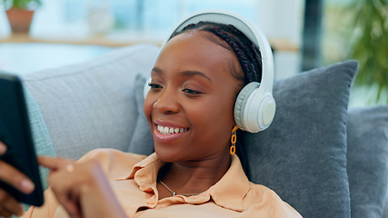 Image showing Happy black woman, headphones and relax on sofa with phone listening to music or podcast at home. Face of African female person smile with headset for audio streaming or sound on living room couch