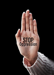 Image showing Open palm, text and closeup to stop oppression for human rights, art solidarity for equality by black background. Hand, overlay and support with motivation, justice or opinion for promotion of peace
