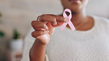 Image showing Hand, person with pink ribbon and breast cancer awareness, health and support with care. Healthcare, campaign with symbol or icon, disease prevention with closeup of bow and wellness with sign