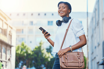 Image showing Phone, walking and young woman in the city networking on social media, mobile app or the internet. Happy, technology and African female person scroll on cellphone and commuting in urban town street.