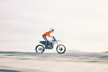 Image showing Speed, desert and extreme sport with biker on motorcycle, precision and race in sun, adrenaline rush and workout. Athlete, goals and target practice with fitness for competition or train in safety