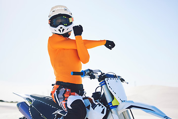 Image showing Motorbike, arm stretch and ready for race in desert, training and practice for challenge on sand dunes. Athlete, fast and adrenaline in extreme sports, fitness and energy for competition on dirt bike