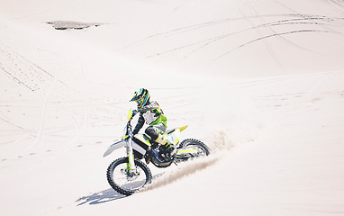 Image showing Man, driving and motorbike on sand for sport, adventure or competition outdoor in summer and mockup space. Motorcycle, ride and athlete on dirt, dune or desert for race, danger and fearless challenge