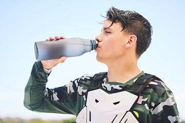 Image showing Man, rider and water for rest after exercise, training or activity on vacation, holiday or travel for competition. Person, racer and break in Namibia for sport, summer and relax with profile in sun