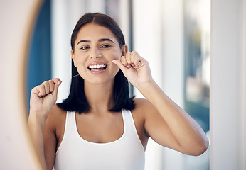 Image showing Dental floss, teeth and woman in mirror of bathroom for oral hygiene, morning routine or gum health. Beauty, wellness and self care with girl and big smile in reflection for cleaning tooth and mouth