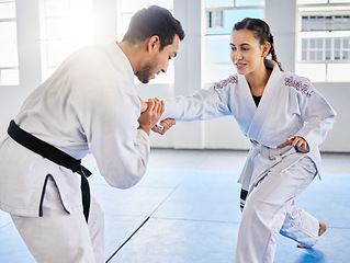 Image showing Man, karate and coach training woman in fitness, workout and exercise class for competition, black belt fight or self defense. Sports athlete, judo teacher and student in taekwondo power punch goals