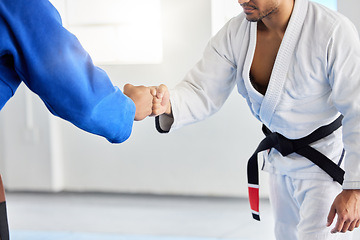 Image showing Karate, fighting tournament and men fist bump in martial arts competition for fighters with sportsmanship, honor and discipline. Man, judo fighters and self defense fight to win in dojo with respect