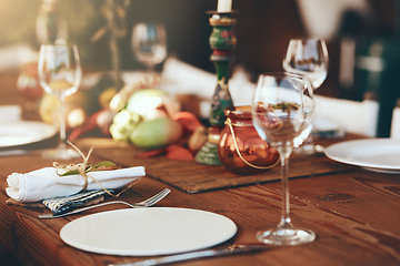 Image showing Table, wine glass and plate for festive holiday meal, drinking and celebration with blurred background. Fine dining, party and glass for wine at feast, dinner or lunch in home, house or restaurant