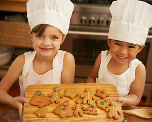 Image showing Portrait, girls and Christmas cookies in kitchen, smile and happy for festive, holiday and joy. Xmas, female friends and baking treats together, for celebration and happiness on vacation and break.