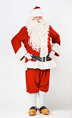 Image showing Santa claus, wink and man in costume in a studio for christmas, fun and hands on hip against a white background mockup. Santa, senior man and emoji portrait by playful male in festive celebration