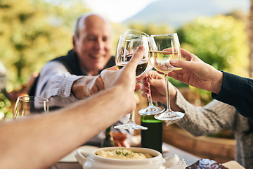 Image showing Friends, wine and toast on a patio with happy, cheerful and people celebrating and sharing a meal outdoors. Family, hands and cheers in celebration of holiday, traditional and happy family gathering