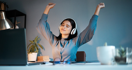 Image showing Woman, night and dance with headphones for music, stress relief or relax singing along alone at home. Female freelancer relaxing, listening or enjoying audio sound track and dancing by workspace desk