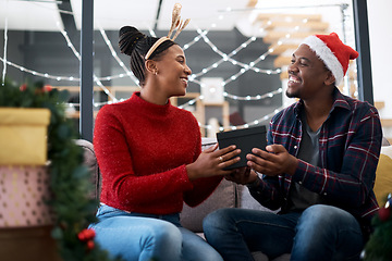 Image showing Gift, couple and christmas celebration on sofa by happy, excited and loving people sharing joy, cheer and giving in their home. black couple, box and gift exchange in a living room, festive and xmas