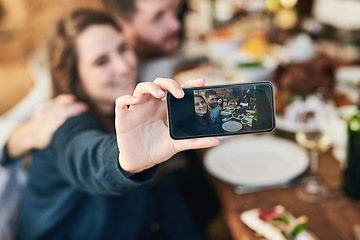 Image showing Couple, family lunch and phone selfie in home at dinner table for thanksgiving celebration memory. Festive fine dining, love and man and woman take picture with mobile smartphone for social media.