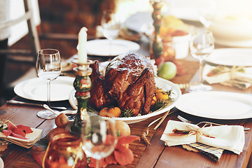 Image showing Thanksgiving, turkey and food with a roast meal on a dinner table for a celebration event or tradition. Christmas, chicken and lunch with a healthy diet on a wooden surface for the festive season