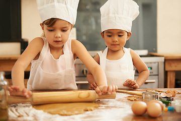 Image showing Baking, helping and children in the kitchen with dough for cookies together in a house. Cooking, baker and young girl friends making baked food, breakfast or a snack with help in a bakery or home