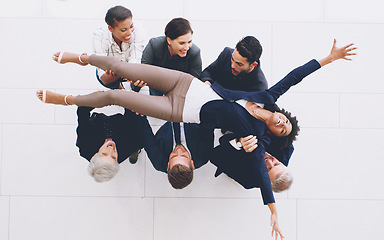 Image showing Top view, business group and carrying woman with joy for successful deal and celebration in the office. Celebrate, success and businesspeople lifting a female staff member for cheering