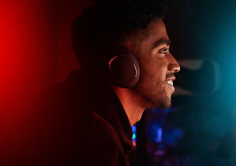 Image showing Headphones, gaming and neon with a man streamer playing a video game online for a subscription service. Gamer, streaming and esports with a male geek or nerd enjoying computer games in a mancave