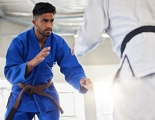 Image showing Martial arts, karate and student learning safety or self defense from a taekwondo expert or master in a dojo. Focus, fitness and fighting instructor coaching, teaching or fighting a healthy man