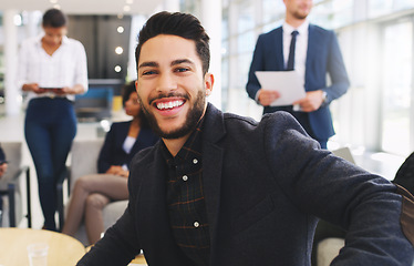 Image showing Portrait, meeting and strategy with a business man sitting in the office with his team or colleague group. Face, marketing and smile wth a happy male employee working with his staff for planning