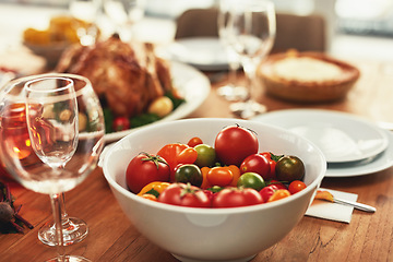 Image showing Food, traditional and celebration with tomato on table for thanksgiving, meal and luxury, turkey and nobody. Chicken, nutrition and family lunch setup for christmas, sunday or family reunion party