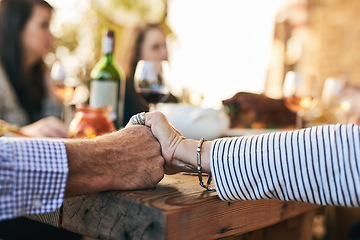 Image showing Hands, pray and party with a senior couple sitting at a dinner day with their family for a celebration. Holding hands, love and prayer with a mature man and woman enjoying a meal together in a home