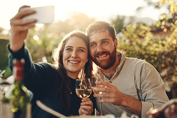 Image showing Wine, phone and couple take a selfie with a toast to a happy marriage and share romantic content on social media. Woman smiles taking pictures on a date with a lovely partner drinking champagne