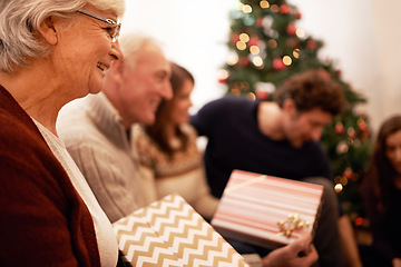 Image showing Christmas, gift and happy with family in living room for celebration, festive and holiday. Smile, party and gratitude with old woman and present with children at home for giving, event and tradition