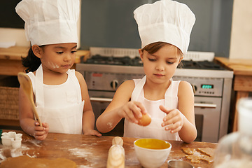 Image showing Children bake in kitchen for learning and development of baker skill, fun with baking ingredients and chef hat with apron. Childhood, focus and girl kids making cookies, diversity and work together.