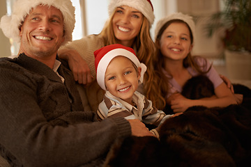 Image showing Mother, father and children on Christmas as a happy family to celebrate a Christian holiday together at home. Celebration, mom and dad enjoy quality time with kids or siblings on sofa in living room