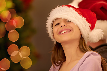 Image showing Portrait, child and christmas in a santa hat to celebrate the festive season with childhood joy and happiness. Holiday, xmas and little girl or kid smiling while celebrating a tradition in december