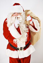 Image showing Father christmas, santa and secret whisper of a fat holiday man with present and gift bag. Celebration event of a hush santa claus with glasses smile with celebration magic of gratitude holidays