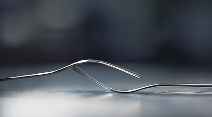 Image showing Silver, balance and fork in studio for catering or eating in a restaurant, house or home on a table with black background. Metal, teamwork and kitchen utensils showing partnership and collaboration