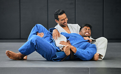 Image showing Mma and karate with a teacher and student training and practicing in a gym with a gi choke. Combat sport, self defense and fighting while preparing for a fight or competition in a sports club