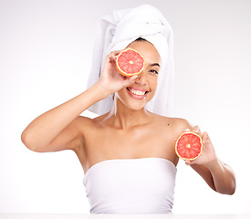 Image showing Woman, face skincare or grapefruit in grooming routine, healthcare wellness or vitamin c dermatology on studio white background. Portrait, smile or happy Brazilian beauty model and citrus facial help