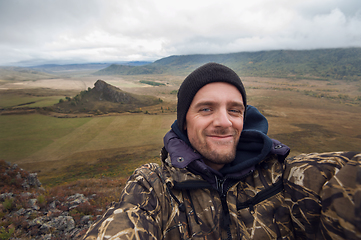 Image showing Caucasian man in the mountain making selfie