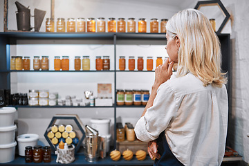 Image showing Honey store owner, grocery shop or woman thinking on shelf ideas, sales product price or stock management. Mature, small business or organic supermarket worker planning bee syrup container promotion